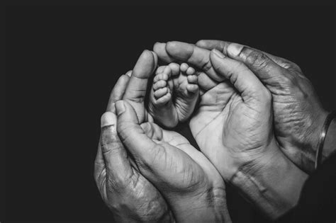 Premium AI Image | A black and white photo of a baby's feet and hands ...