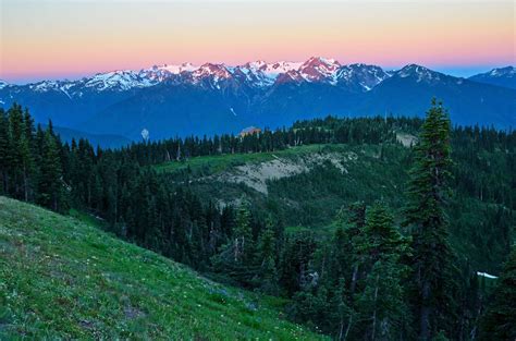 Hurricane Ridge visitor center with early morning alpine glow on the Olympic range ...