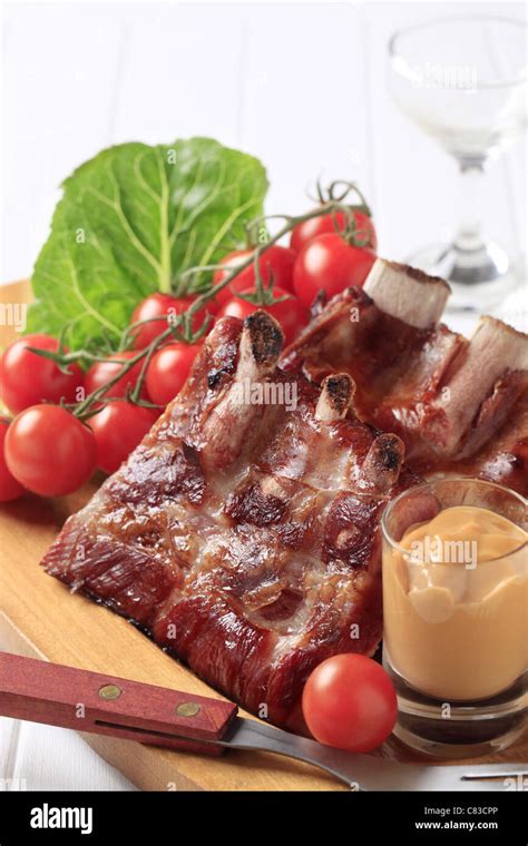 Smoked pork ribs and spicy sauce - still Stock Photo - Alamy