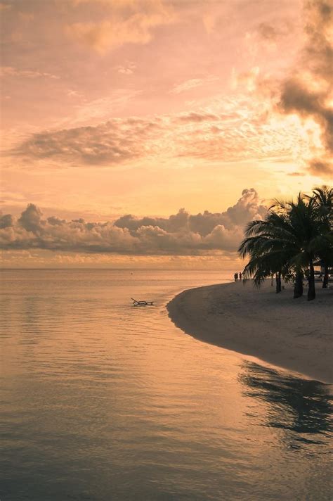 Sunset over an island in the Maldives. | Dream vacations, Beautiful beaches, Sunset