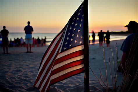 Premium AI Image | An american flag on the beach at sunset