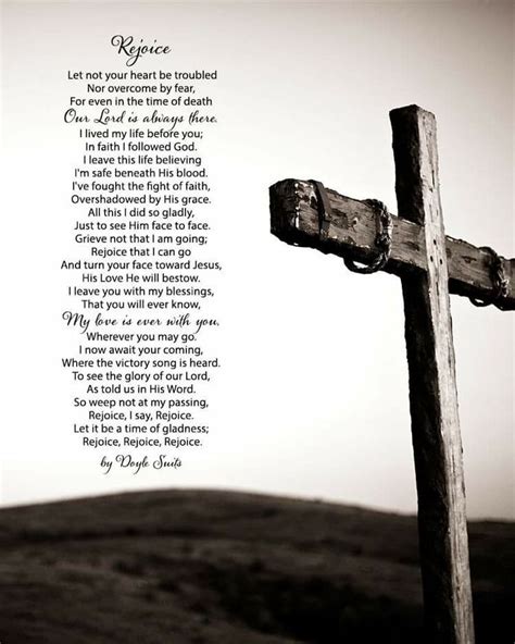 a wooden cross sitting on top of a hill with a poem written in the middle