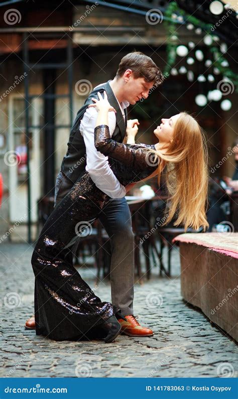 Joyful Young Couple in Love Dancing Latin on Evening Street Near the ...