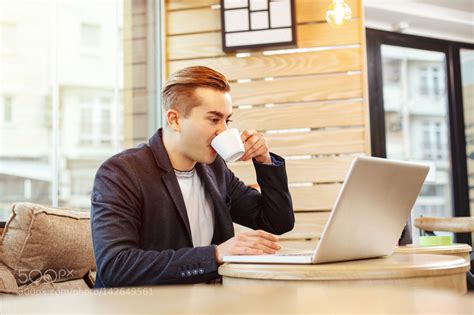 Young businessman drinking coffee in a cafe by djile | Coffee drinks, Coffee, Business man