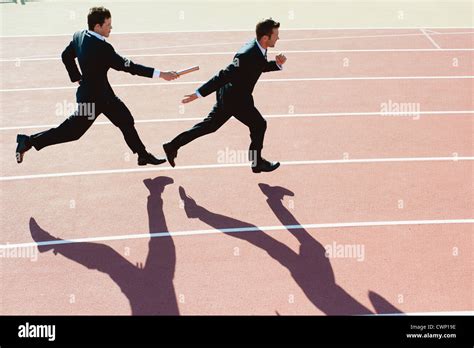 Businessmen running relay race Stock Photo - Alamy