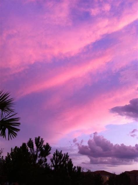 the sky is pink and purple with clouds