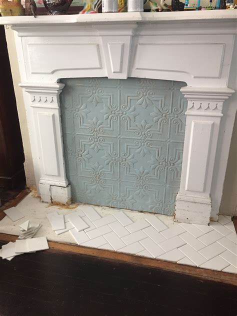 Painted plastic “faux tin" fireplace cover with herringbone tile ...