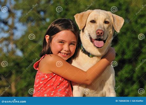 Happy child hugging a dog stock photo. Image of animal - 76868336