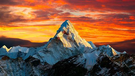 Download 4K Mountain Under Orangish Sky Wallpaper | Wallpapers.com