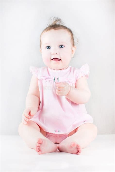 Cute Baby Girl Sitting And Wearing A Pink Dress Stock Image - Image ...