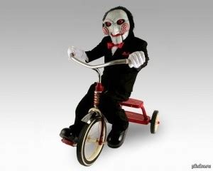 Create meme "the doll from saw on the bike, Billy doll on the bike, saw ...