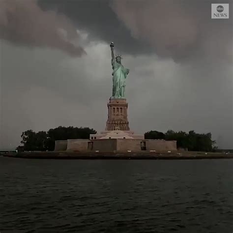 LIT UP: Lightning strikes in the distance behind the Statue of Liberty ...