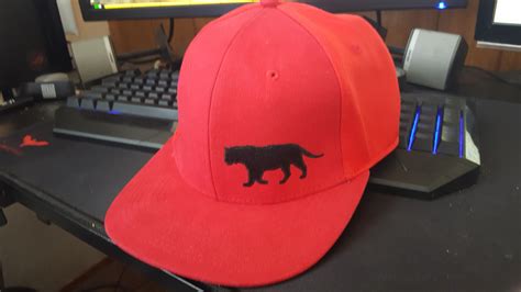 Red hat with black cat logo, there is no descriptive markings anywhere ...