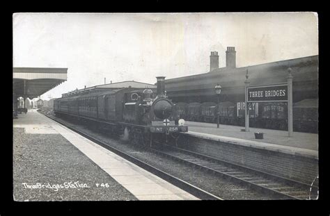 A photographic postcard titled 'Three Bridges Station' in Sussex.