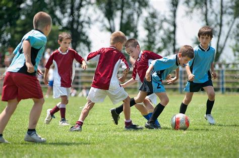 Kids playing football Stock Photo by ©fotokostic 20997099