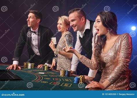 Group of a Stylish Rich Friends are Playing Poker at Casino. Stock ...