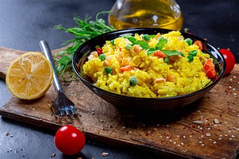 Stewed vegetables in a bowl on a dark background with fresh basil and ...