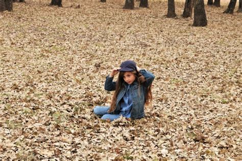 Young Girl Sitting In Autumn Leaves Free Stock Photo - Public Domain Pictures