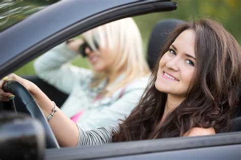 Smiling girl driving a convertible car Photo | Free Download