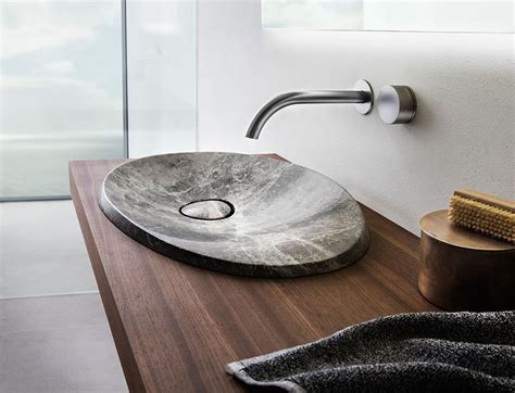 The design of this natural stone sink is inspired by the shape of ...