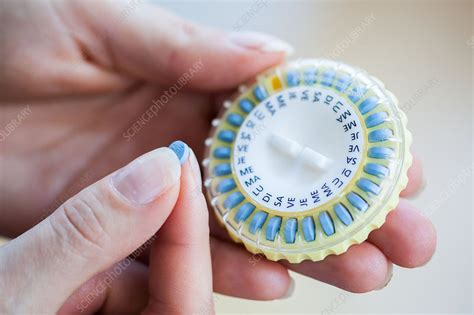 Woman taking hormone replacement therapy pills - Stock Image - C034 ...