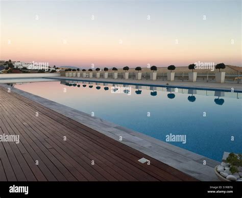 Sunset reflected in pool Stock Photo - Alamy