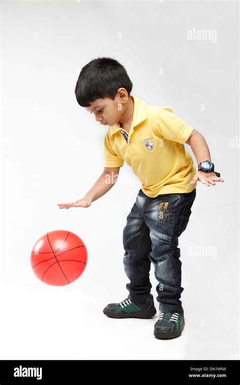 Little 5 year old Indian kid throwing up a ball Stock Photo: 57815890 - Alamy