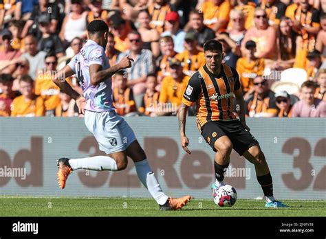 Ozan Tufan #7 of Hull City looks to go past Andrew Omobamidele #4 of ...