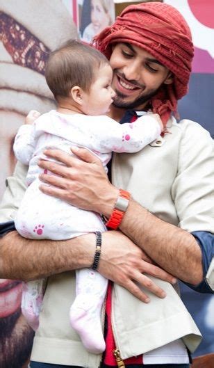 Omar Borkan Al Gala. Hot guy + baby = Me swooning...wishful thinking that possibly may be haram ...