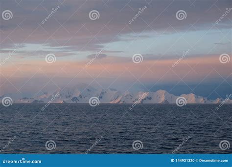 Antarctica Calm Pink and Blue Sunset Over Snow Capped Mountains Stock ...