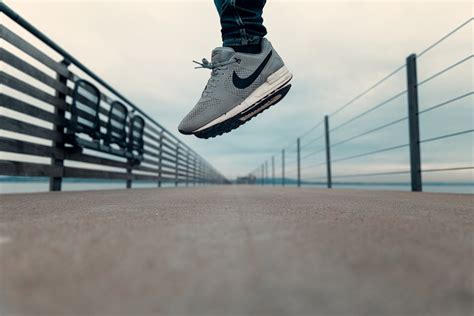Person Wearing Gray Nike Shoes · Free Stock Photo