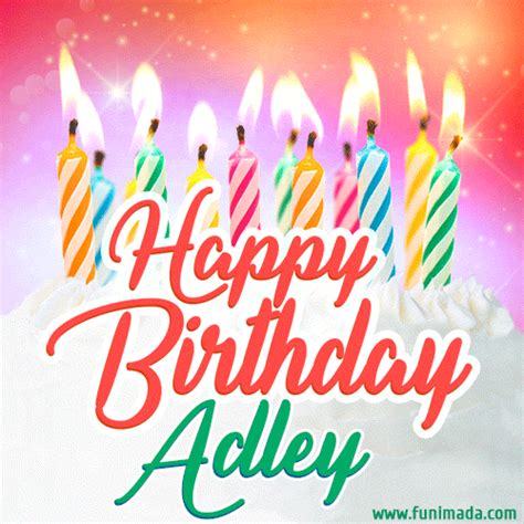 A white creme cake with colorful candles and the words 'Happy Birthday Adley' in a handwritten ...