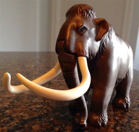 an elephant figurine is shown on a counter top with it's tusks curled up