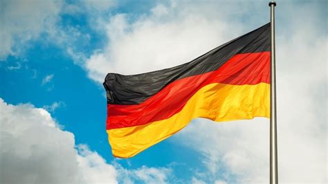 Premium Photo | German flag fluttering in the wind in berlin germany