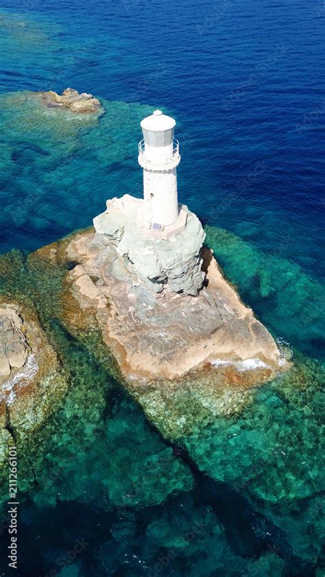 Aerial drone bird's eye view of iconic lighthouse of Tourlitis in port ...