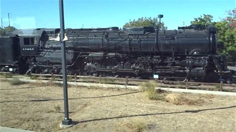 San Joaquins Amtrak Train Passing an AT &SF Steam Engine on Display at ...