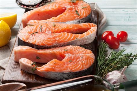 Raw salmon fish steaks stock photo. Image of rosemary - 118172516