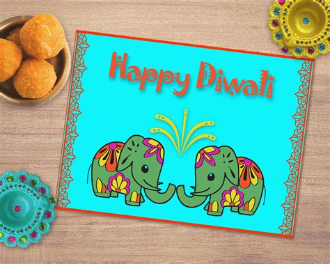 an image of happy diwali greeting card with two elephants on the table next to it