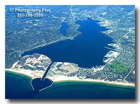 A high aerial view showing all of Muskegon Lake on the east shore of ...