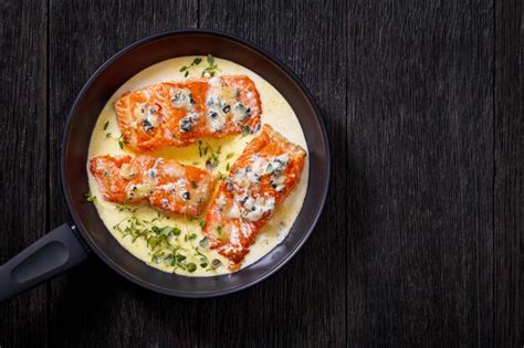 Premium Photo | Salmon fillet with creamy blue mold cheese sauce