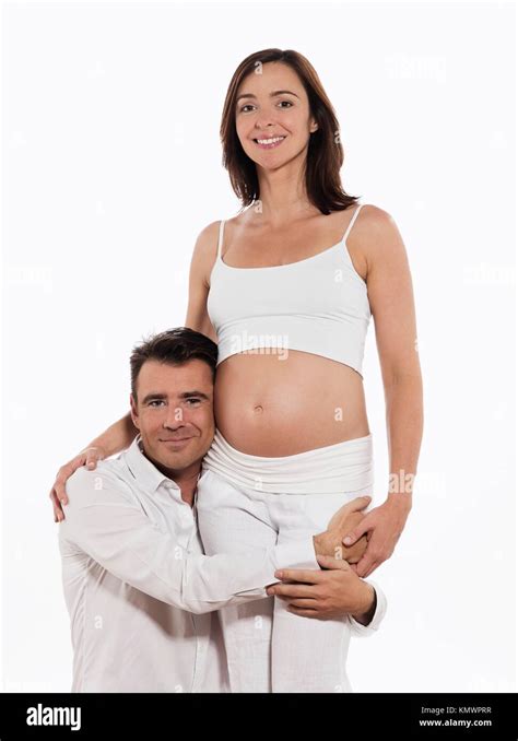 caucasian couple expecting baby wellness hugging isolated studio on white background Stock Photo ...