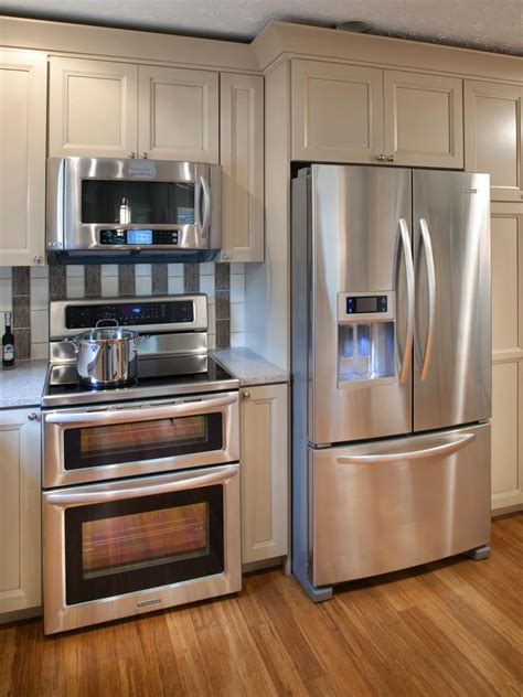 Neutral kitchen cabinets provide convenient storage and a clean facade in this kitchen ...