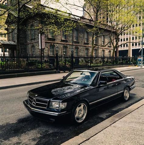 a black mercedes benz coupe parked on the street