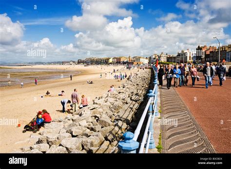 Morecambe beach and seafront promenade looking toward the clock tower, Lancashire, England, UK ...