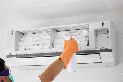 air conditioner cleaning with spray foam cleaner 13021960 Stock Photo at Vecteezy