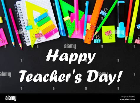 Happy Teachers Day. School supplies on blackboard background ready for your design. Flat lay ...