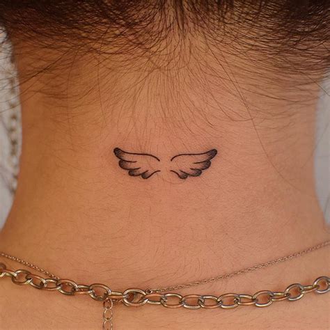 Angel wings tattoo located on the back of the neck,