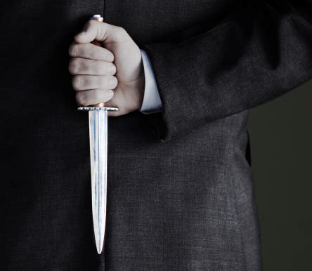 Midsection Of Businessman Holding Knife Stock Photo - Download Image Now - iStock