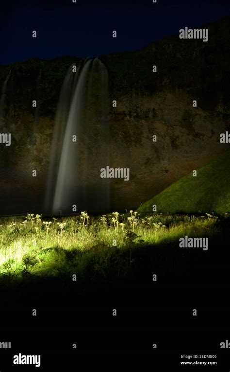 Waterfall Seljalandsfoss at night time in Iceland Stock Photo - Alamy