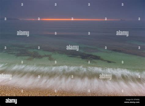 Sunrise from Gyllyngvase beach in Cornwall Stock Photo - Alamy